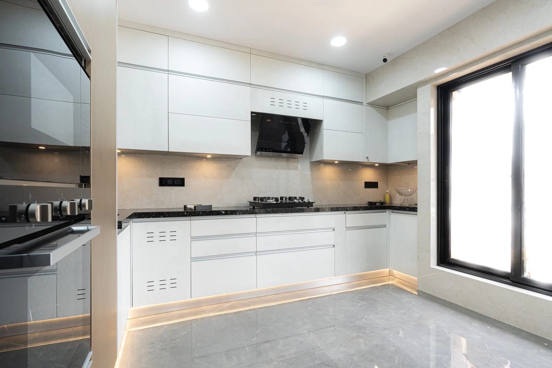 C-Shaped White and Gold Modular Kitchen